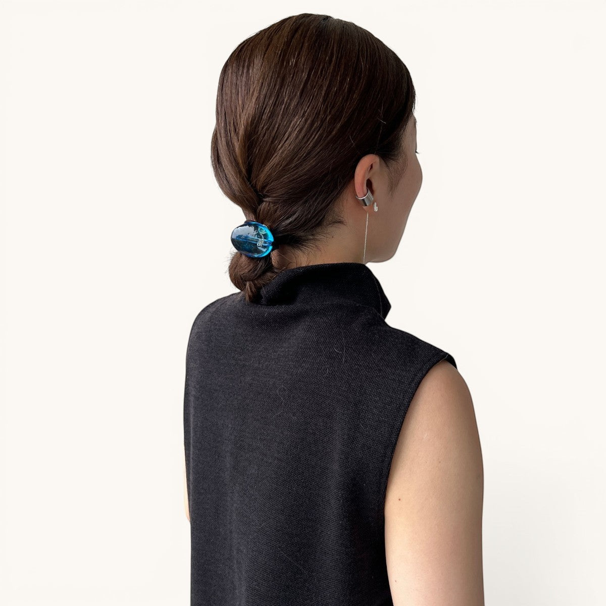 THE HAIR BAR TOKYOのルーサイト製ジェムポニー。ブルーのグラデーションが美しいオーバル型のヘアアクセサリーを着用した後ろ姿。